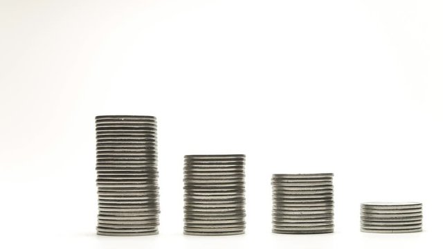 Silver coins on stacks are decrease and increase on white background stop motion animation