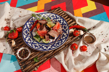 Fototapeta premium Dishes of Uzbek cuisine on a red background and beautiful decoration.
