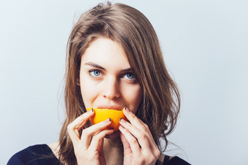 young beautiful woman with citrus orange fruit having fun.