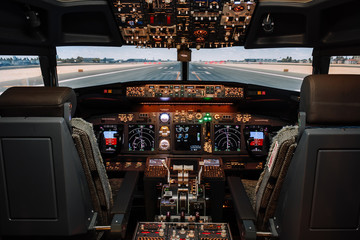 Full view of cockpit modern Boeing aircraft before take-off. Airplane is ready to fly. Landscape...