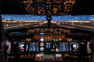 Dramatic Full view of cockpit modern Boeing aircraft before take-off. Airplane is ready to fly. Night shot in cabin. Safety flight - obrazy, fototapety, plakaty