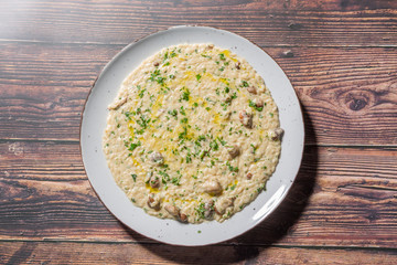 Risotto with mushrooms and cheese served on a restaurant table