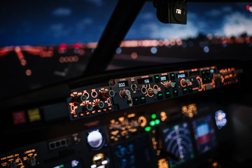 Autopilot controller. Display navigator system of Boeing aircraft. Automatic landing system. Night shot inside cabin. ILS - 338538593