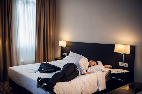Tired Businessman resting in a hotel room