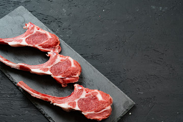 Raw fresh lamb ribs on dark background, close up. © fotofabrika