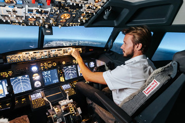 First officer is controlling autopilot and parameters for safety flight. Cockpit of Boeing...
