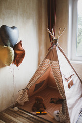 Children's wigwam for a beige boy. In the nursery. © Дмитрий Чапурин
