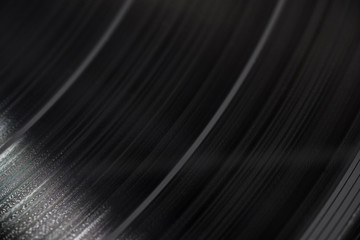 Part of black vinyl music plate with sound tracks on it, closeup