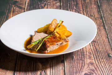 Roasted veal with fried potato served on a restaurant table