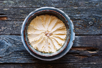 Fototapeta na wymiar Useful chickpea flour in a ceramic bowl on a wooden table Healthy vegan ingredient 