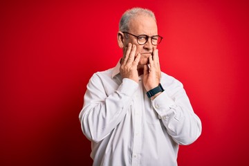 Middle age handsome hoary man wearing casual shirt and glasses over red background Tired hands covering face, depression and sadness, upset and irritated for problem