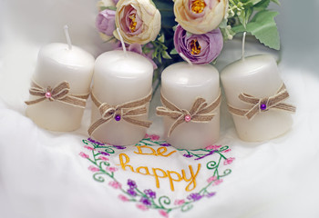 white candles with bows and flowers