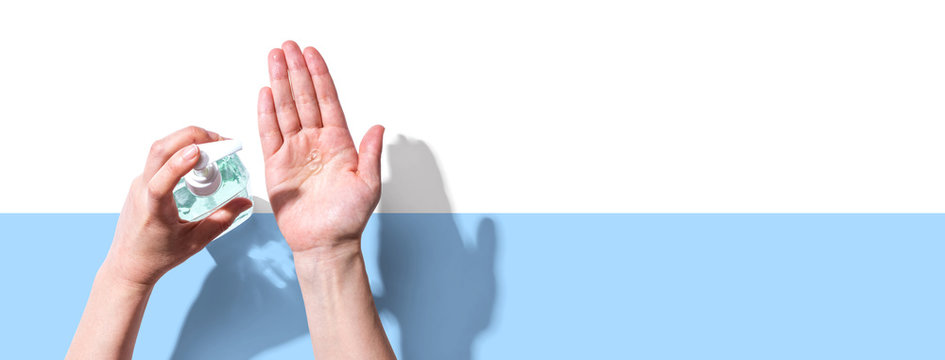 Applying sanitizer gel - healthcare and hygiene concept