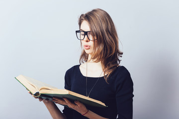 Woman with big book. On a gray background.