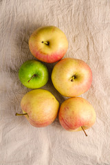 Fresh sweet apples on reusable textile grocery bag on dark grey background, top view
