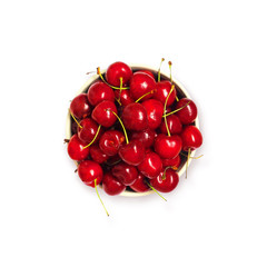Obraz na płótnie Canvas Fresh sweet red cherry in plate isolated on a white background, top view. Prunus avium