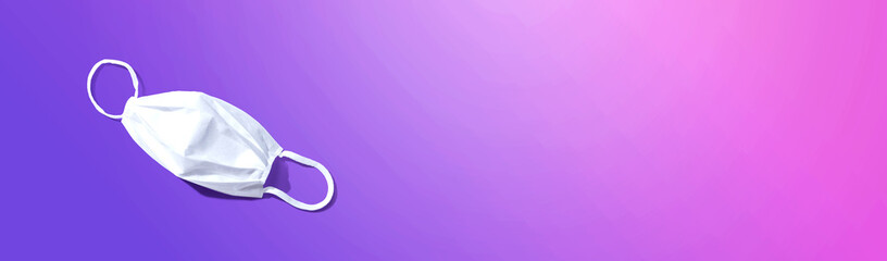 White surgical mask overhead view - flat lay