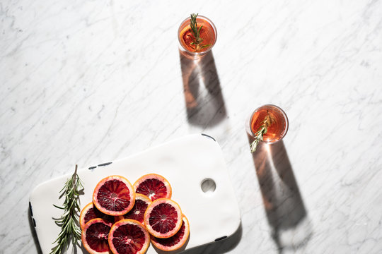 Cocktails in the sun with blood oranges