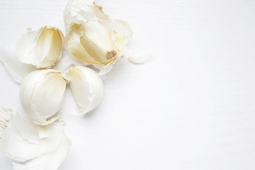 garlic cloves on white table