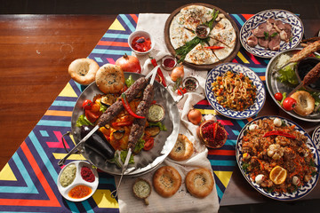 Dishes of Uzbek cuisine on a red background and beautiful decoration.