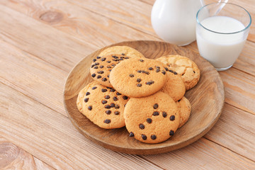 Plate with sweet cookies on table