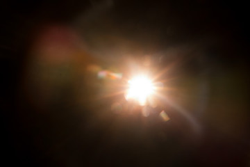 Abstract Natural Sun flare on the black background.