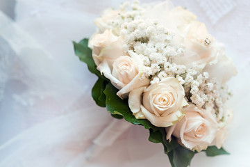detail of pink fresh roses bouquet with Gypsophila paniculata. Wedding ceremony