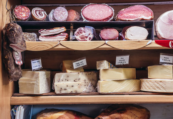 Cheese and meat in Antica Formaggeria Bernadi store in historic part of Bologna city, Italy