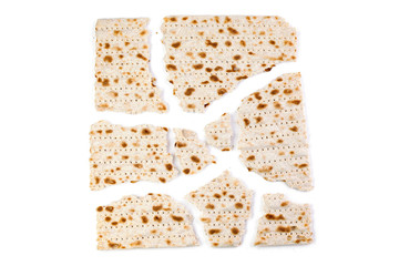 Matzo. Traditional jewish easter bread. Passover holiday symbol. Broken matzo, lies in a heap. Isolated on white. With some free space for your text or sign. Close-up.
