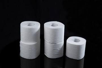 Toilet paper is white on a black background. Hygiene products.