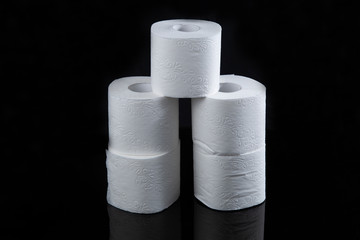 Toilet paper is white on a black background. Hygiene products.