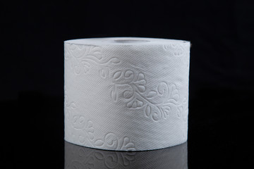Toilet paper is white on a black background. Hygiene products.