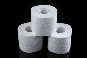 Toilet paper is white on a black background. Hygiene products.
