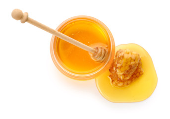 Jar of sweet honey and combs on white background