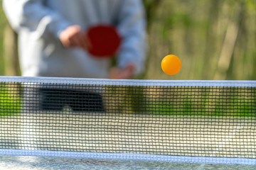 Tischtennis spielen im Freien: Jugendliche im Park / im Grünen