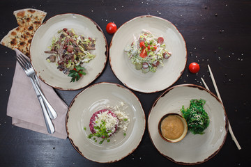 Dishes salad on a plate in a restaurant.