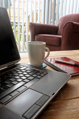 Laptop, coffee and notebook
