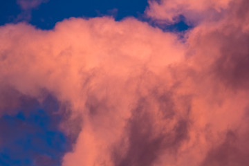 pink clouds on a background of blue sky at sunset