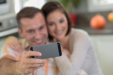 Young couple doing a selfie in the kitchen