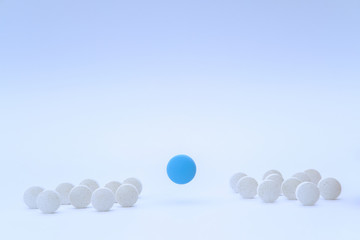 White and blue flying pills collection on white background. Vitamin deficiency, avitaminosis concept. Homeopathy cure treatment, Healthy Lifestyle, Protection from virus. Front view