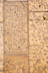 Huge yellow ancient stones of the Wall of Tears with notes between
