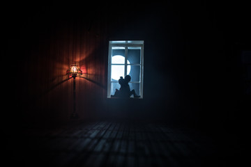 A realistic dollhouse living room with furniture and window at night. Artwork table decoration with handmade realistic dollhouse.