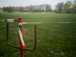 Outdoor soccer field blocked with barrier tape during Corona pandemic lockdown on Easter Monday...