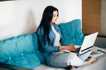 Remote work and online study. Young designer or illustrator at work. Young woman working on laptop...