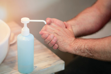 A man desinfection hands,  using antibacterial gel. Prevention of  covid-19 , other virus and bacteria.