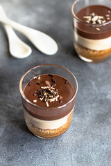 Cup chocolate dessert with coconut cream 