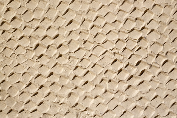 The texture of the plastered wall. Rough corrugated cement surface. Uneven angular pattern. Perfect for background and design.