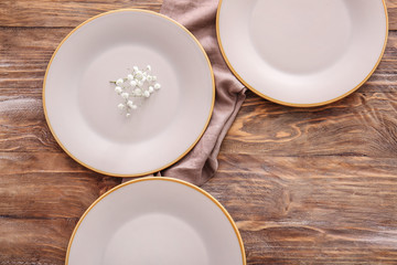 Clean plates on wooden background