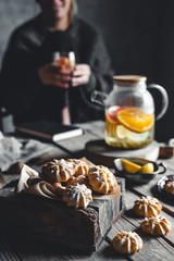 Woman is sitting with Hot tea with fresh grapefruit on wooden tablet. Healthy drink, Eco, vegan.