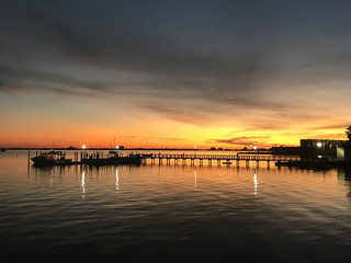Obraz premium Sunset over a boardwalk in the summer